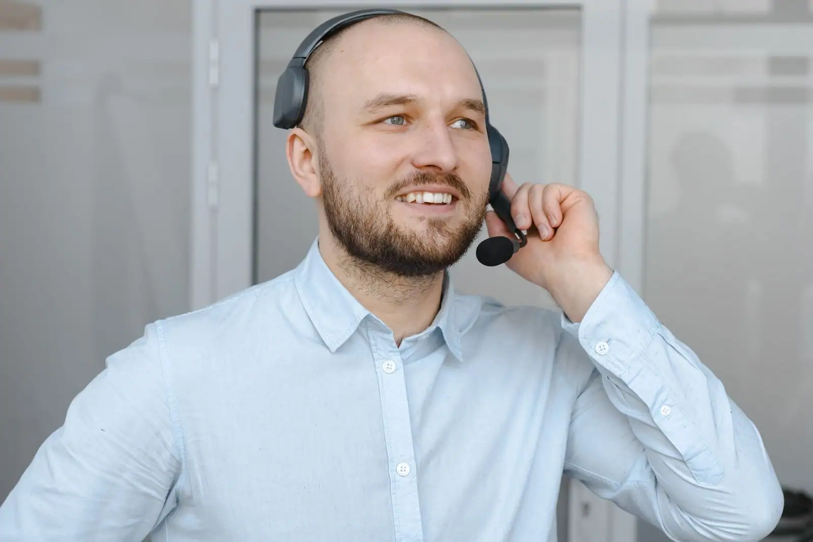 Conseillère en relation client au téléphone avec un casque dans un bureau ouvert